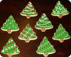 cookies decorated like christmas trees on a table