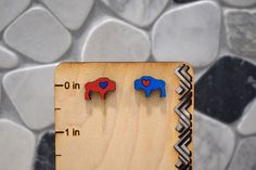 Let's go Buffalo! The perfect earrings to finish your outfit for the next big game!  Our earrings are made out of a variety of different woods which could be Mahogany, Cherry, or Sapele. All earrings have been designed, printed, painted and sealed by me! Since these earrings are handmade, each pair may have slight variations from the other. After I print the earrings, I hand paint with acrylic paint and seal with clear Rustoleum to preserve the earrings. Due to the earrings being made out of woo Lets Go Buffalo, Bills Mafia, Buffalo Football, Football Earrings, Gifts For Football Fans, Hand Paint, Red Paint, Big Earrings, Lets Go