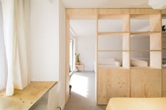 a room with wooden shelves and white walls