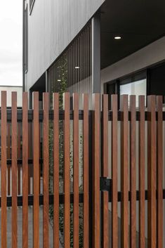 a wooden fence is in front of a building