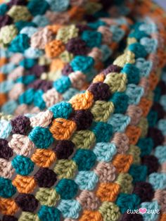 a crocheted blanket is shown with multicolored squares