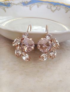 Gorgeous pair of earrings featuring crystals in morganite pink and pale champagne. 1 1/2 inches long. 7/8 inch wide. Rose gold plated settings. Also available in silver or gold. Please select metal finish from the drop down menu at checkout. Thanks for stopping by! Pink Wedding Accessories, Navy Blue Earrings, Crystal Cluster Earrings, Swarovski Crystal Drop Earrings, Blush Earrings, Large Statement Earrings, Blush Bridal, Gift Wine, Swarovski Crystal Bracelet