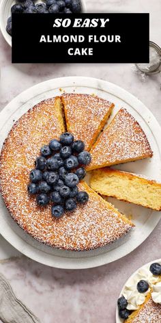 a cake with blueberries on top and the words so easy almond flour cake above it