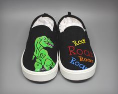 Hand painted Dinosaur sneakers customized to your liking. Perfect for any Dinosaur Fan! When purchasing a pair of these shoes, you need to choose either an adult or children's pair of shoes. The children's shoes go up to a size 5. Any size larger than that is considered an adult shoe.  The shoes included in this listing will be a generic brand such as Wonder Nation or Faded Glory. If you would prefer a specific brand, it can be done for an additional fee. The base shoe style and/or color may vary depending on what is available. Made in a smoke free home.  Because of made to order customization, no refunds or exchanges available. If you have any questions, just send me a message. Painted Dinosaur, Sneakers Customized, Mickey Shoes, Dinosaur Shoes, Shoes Customized, Dinosaur Fabric, Dinosaur Themed Birthday Party, Vans Toddler, Custom Painted Shoes