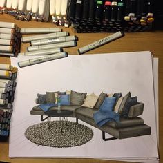 a drawing of a couch and some crayons on the table next to it