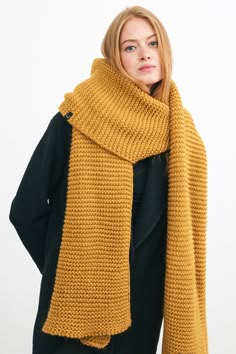 a woman wearing a yellow knitted scarf