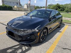 a black car parked in a parking lot