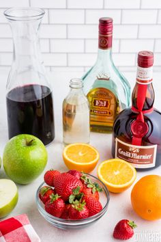 an assortment of fruit and liquor on a table