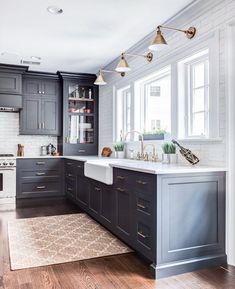 an image of a kitchen with gray cabinets and white counter tops on facebook advertisming