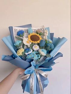 a bouquet of flowers is being held by someone's hand