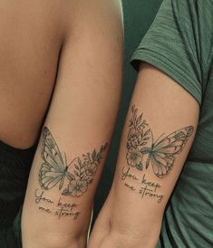 two women with matching tattoos on their arms, one has a butterfly and the other has flowers