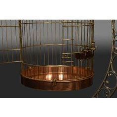 a golden birdcage with candles in it