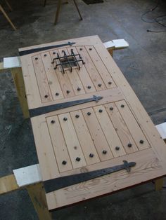 a table made out of wooden boards and nails