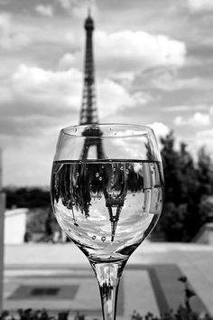 an empty wine glass with the eiffel tower in the background