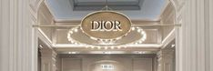 the entrance to dior's showroom is lit up with christmas lights and decorations