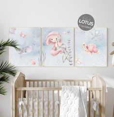 a baby's room with two paintings on the wall