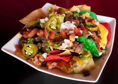 a white plate topped with taco salad and tortilla chips