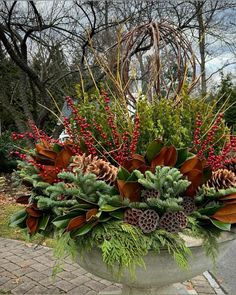 a planter filled with pine cones and evergreens