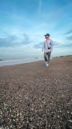 a man is running on the beach in front of the ocean