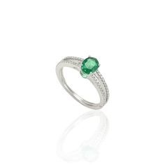 Genuine Oval Cut Emerald and Diamond Ring in 18K Gold featuring natural emerald of 0.56 carat and diamonds of 0.2 carat. The gorgeous handcrafted ring goes with every style. Emerald enhances intellectual capacity of the person. Designed with oval cut emerald set in center and diamond studded on split shank that makes it a perfect fit to wear it on your occasion or style it with any of your basic outfit to give it a glam. This is a perfect emerald and diamond ring. It can be a Best Friend Gift, Bridal Shower Gift, Secret Santa Gift, Gift For Sister, Mother Daughter Gift, Bride To Be Gift, Bridesmaid Gift, Thanksgiving Gift, Thank You Gift, Anniversary Gift, Christmas Gift or any Holiday Gift for Mother, Sister, Daughter, Grandma, Fiancé, Girlfriend, Valentine, Family or Friend on your list. Gemstone Solitaire Ring, Sapphire Solitaire Ring, White Gold Solitaire, Mother Daughter Gifts, Gold Solitaire Ring, Sapphire Solitaire, Emerald Color, Modern Ring, Handcrafted Rings