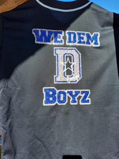 we dem boyz t - shirt hanging up on a clothes rack in the sun