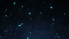 snow flakes are falling from the sky at night, with green lights shining on them