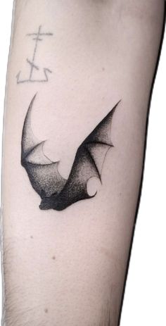 a black and white photo of a bat tattoo