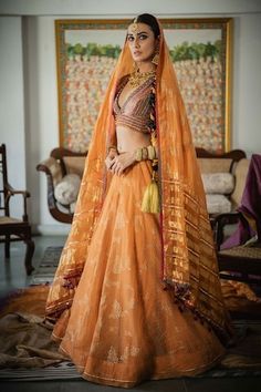 Kesaria orange striped lehenga with handblock foil print, embellished with hand embroidery and fringing. - Aza Fashions Traditional Orange Sharara With Bandhani Print, Traditional Orange Bandhani Print Sharara, Orange Anarkali With Bandhani Print, Orange Chanderi Lehenga With Dupatta, Orange Bandhani Print Dupatta For Wedding, Orange Bandhani Print Sharara For Festivals, Orange Bandhani Print Wedding Dupatta, Orange Bandhani Print Sharara For Festive Occasions, Orange Bandhani Print Sharara For Festive Season