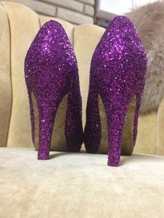 Royal purple covers the entire top portion of the heels while the underside is covered in an ultra-fine yellow gold glitter. These heels can be made in any color combo desired. If you would like another color combination please leave your color choices at checkout. This heel is available in additional colors and shoe styles. Contact us today for more color and style options. All heels are handmade and shipped out within 1-2 weeks of the purchase date. We always welcome new designs and love to wo Tall Heels, Heels Purple, Heels Short, Glitter High Heels, Short Heels, Costume Shoes, Purple And Yellow, Gold Heels, Royal Purple