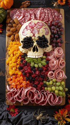 a skull made out of fruits and vegetables on a cutting board