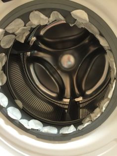 an overhead view of the inside of a washing machine with rocks and stones around it