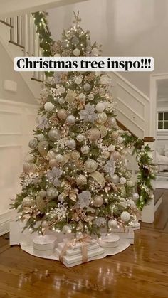 a decorated christmas tree with presents under it and the words, christmas tree inspo?