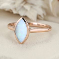 Embrace marquise marvel with our 1Ct Marquise Cut Opal Bezel Ring in Rose Gold, the perfect choice for a solitaire engagement that shimmers with elegance. Bezel Ring, Ring Rose Gold, Affordable Jewelry, Marquise Cut, Solitaire Engagement, Lab Diamonds, Gift For Women, Rose Gold Ring, Custom Jewelry