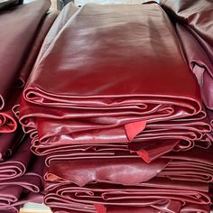 a pile of red leather sheets sitting on top of each other