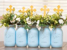 four blue mason jars with flowers in them