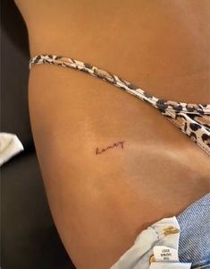 a woman's stomach with the word mom written on her left side ribcage