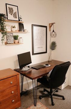 an office with a desk, chair and pictures on the wall above it is shown