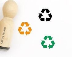 a rubber stamp with three recyclables and the words save our earth on it