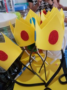 two paper crowns sitting on top of a table