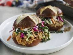 two pulled pork sandwiches on a white plate