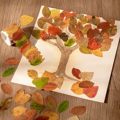 an autumn tree made out of leaves on a piece of paper