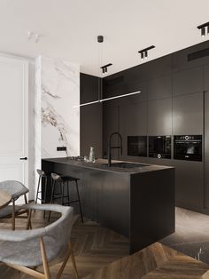 a modern kitchen with marble counter tops and black cabinets