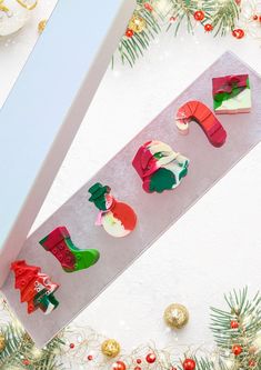 the christmas cookie is decorated with santa's hats and stockings