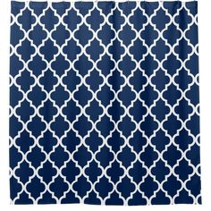 a shower curtain with blue and white geometric pattern on the outside, in front of a white background