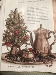 an advertisement for christmas tea with a tree and other ornaments on it's tray