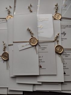 many wedding cards with wax stamp on them are laid out in front of each other