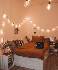 a bedroom with lights strung above the bed