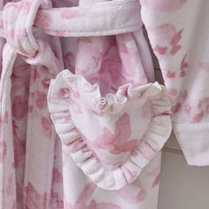 Adorned with pink roses atop an ivory ground, this robe lets you lounge in dreamy style. It boasts charming, heart-shaped pockets and an adjustable sash belt so you can relax in total comfort. Plus, the cotton terry construction makes it all the more cozy and inviting. Designed exclusively for Pottery Barn Teen by lifestyle brand LoveShackFancy. KEY PRODUCT POINTS OEKO-TEX(R) STANDARD 100: tested for 1000+ harmful substances to keep you and your family safe from chemicals common to textile manuf Short Robes For Women, Love Shack Fancy Suitcase, Loveshackfancy Robe, Random Things To Buy, Cute Robes, Fancy Robes, Sofia The First Birthday Party, Dreamy Style, Jessica Day