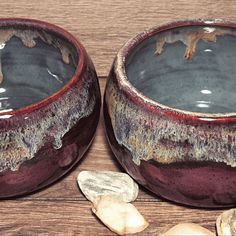 two ceramic bowls with rocks and water in them