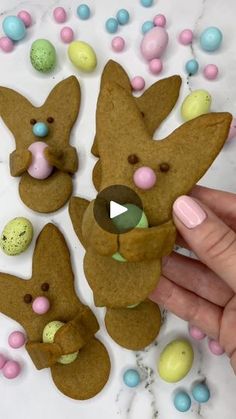 someone is holding up some cookies to make them look like rabbits